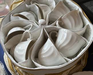 White china cups in quilted storage case