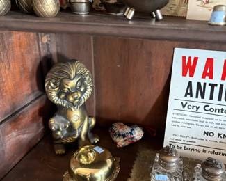 Cast metal lion and novelty signs