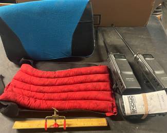 Two handheld radios, beam/measuring tool, blue cushion, red padded wrap