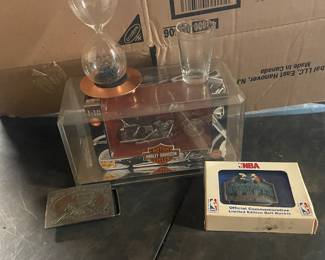 Harley-Davidson motorcycle in its orginal packaging and two belt buckles. Shot glass and a hour glass with a magnet stand.