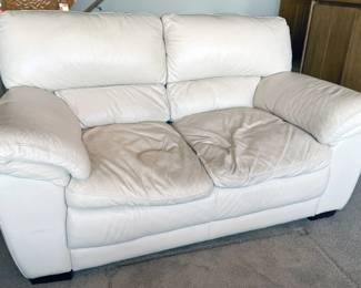 Cream colored leather love seat