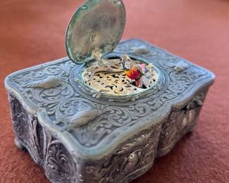 Antique self silver pop-up bird music box has corrosion