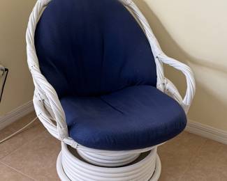 Beautiful 3-piece white rattan conversation set featuring two swivel lounge chairs with navy cushions and a matching round glass-top table. A perfect addition to a Florida room, lanai, sunroom, or coastal-inspired living space.
