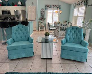 Beautiful pair of aqua tufted swivel accent chairs with plush seating and classic button-tufted backs. A perfect addition to a living room, reading nook, bedroom, or Florida home with coastal-inspired décor.