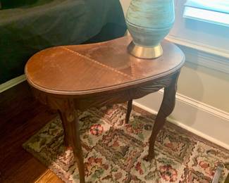 one of two kidney shaped side tables