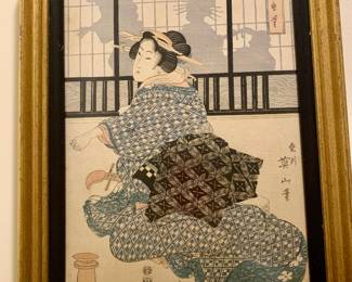 framed woodblock print by Kikukawa Eizan depicting a geisha in a patterned kimono
