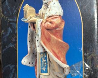 Fontanini Melchior 7.5" Heirloom — Fontanini Melchior from the Fontanini Heirloom Collection, a 7.5" hand-painted resin/wood-appearance nativity figure in regal robes. The piece shows detailed paintwork with a fur-trimmed cloak and crown, typical of Fontanini collectible nativity figures. Boxed item (box shows storage wear and tape) — figure likely in good collectible condition though item not removed for inspection. Good estate-sale pick for seasonal collectors; minor box wear and surface scuffs noted.