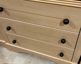 3-Drawer Wood Dresser with Black Top — This stylish dresser features a maple wood body with a contrasting black top, offering a modern yet classic look. It has four drawers with simple black knobs that provide ample storage space. Measuring approximately 35 inches high, 40 inches wide, and 18 inches deep, it is a versatile piece suitable for a bedroom or bonus room. The dresser is in good condition with minor surface scratches on the black top but structurally sound. A practical and attractive furniture piece for home organization.