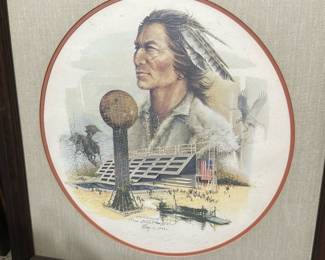 Signed Native Portrait Limited Print — Limited-edition lithograph featuring a Native American portrait with the Sunsphere and Tennessee World's Fair pavilion imagery, signed and dated May 1, 1982. The print is matted in a round opening with a linen-style mat and set in a dark wood frame; artist signature and edition number (e.g., 67/100) visible near the lower image. Overall framed piece is moderately large and suitable for a den or bonus room display. Condition is good with light surface wear to the mat and frame and no obvious tears to the print; glass appears intact but may have minor scuffs.