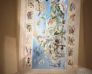 North Carolina Wildlife Places Map — Colorful illustrated North Carolina wildlife map poster showing state landmarks, animals and coastal life. Printed poster on paper with illustrated border vignettes and title text; appears unframed and stored flat in a cardboard box in the bonus up room. Estimated overall size fits a large poster — see dimensions below — and it's lightweight for easy pickup. Condition appears good with slight edge wear and small corner dings visible in photos but no major tears or stains.