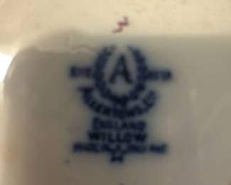 Allertons Ltd Blue Willow Sugar Bowl — This charming sugar bowl features the classic Allertons Ltd English Blue Willow pattern with its iconic blue and white design. Crafted from fine porcelain, it includes a fitted lid and dual handles for ease of use. Measuring approximately 3.5 inches in height and 5 inches wide including handles, it is a perfect addition to any tea or dining set. The piece is in good condition with mild wear consistent with age and no visible chips or cracks. Marked on the bottom with the Allertons Ltd maker's stamp and 'Made in England' designation, this bowl represents fine English china craftsmanship.