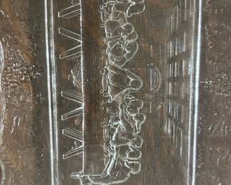 Vintage Glass Last Supper Tray — This vintage clear glass tray features an intricate etched depiction of the Last Supper surrounded by a grapevine border. The detailed scene sits prominently in the center of the rectangular tray with scalloped edges, perfect for serving or display. Measuring approximately 15 inches in length and 9 inches in width, it is a delicate piece suitable for collectors of religious or vintage glassware. The tray is in good condition with some minor surface wear consistent with age but no chips or cracks. A unique decorative item ideal for a bedroom or dining area display.