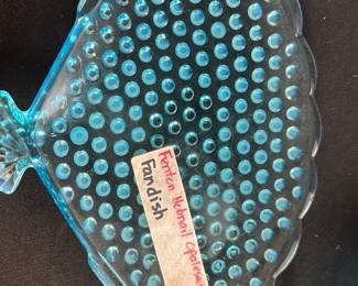 Fenton Hobnail Opalescent Dish — This charming Fenton hobnail opalescent fan dish features a distinctive hobnail texture and an opalescent blue finish that beautifully catches the light. Crafted from high-quality glass, the fan-shaped dish combines both decorative appeal and practical use. The dish measures approximately 8 inches in height, 7 inches in width, and 1 inch in length, making it a perfect accent piece for display or serving small items. It is in good condition with some light surface wear consistent with use but no chips or cracks. This piece exemplifies Fenton's classic art glass craftsmanship and makes a lovely addition to any vintage glass collection.