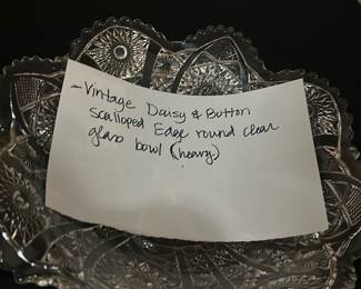 Vintage Daisy & Button Glass Bowl — This vintage Daisy & Button clear glass bowl features a distinctive scalloped edge and detailed pressed glass pattern, showcasing classic craftsmanship. The bowl is heavy and robust, making it ideal for display or serving. It measures approximately 8 inches in diameter and stands about 2.5 inches tall. The bowl is in good condition with no visible chips or cracks, preserving its vintage charm. Perfect for collectors or as an elegant decorative piece, this bowl embodies mid-20th century glassware design.