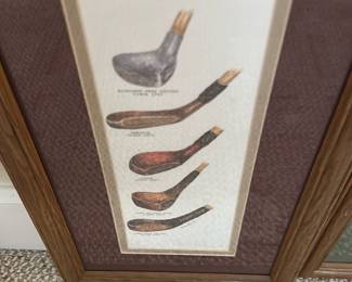 Framed Vintage Golf Club Print — This framed vintage print showcases a detailed illustration of antique golf clubs, highlighting the evolution of their design. The artwork is enclosed in a wood-tone frame with a double mat, offering a classic presentation suitable for a golf enthusiast's collection or decor. Measuring approximately 18 in height by 10 in width, this piece fits well in a study or bedroom up room. The print and frame are in good condition with minor wear consistent with vintage items. A charming collectible for both golfers and vintage sports memorabilia collectors.