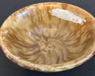 Small Brown Ceramic Bowl — This small brown ceramic bowl features a unique marbled glaze with an aged crackle finish, giving it a vintage charm. Its rounded form and smooth texture indicate traditional ceramic craftsmanship. The bowl measures approximately 2.5 inches in height and 5.5 inches in diameter, making it ideal for decorative or small serving uses. The piece shows minor signs of wear consistent with age, including slight surface crazing but no visible chips or cracks. Its neutral earthy tones complement a variety of décor styles, especially rustic or vintage collections.