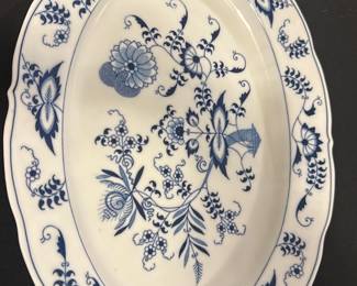 Blue Danube Blue and White Platter — This Blue Danube oval serving platter features an intricate blue floral pattern on crisp white porcelain, showcasing traditional Asian-inspired design. Measuring approximately 15 inches in length and 12.5 inches in width, this piece is ideal for serving or decorative display. Crafted from fine porcelain, it is marked with the Blue Danube maker's stamp on the bottom. The platter is in good condition with no visible chips or cracks, exhibiting only minor signs of use. Perfect for collectors or those looking to add classic blue and white china to their dining collection.