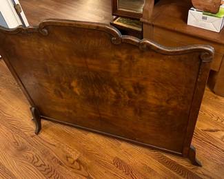 Vintage Wood Fireplace Screen — This vintage wooden fireplace screen features an elegant curved top with intricate scroll details. Crafted from rich wood with a warm brown finish, it adds a classic touch to any living room setting. Measuring approximately 30 inches in height and 46 inches in width, it is a functional and decorative piece ideal for home hearth protection. The screen is in good condition with minor scratches and wear consistent with age but no major damage. This timeless accessory blends well with traditional and vintage decor styles.