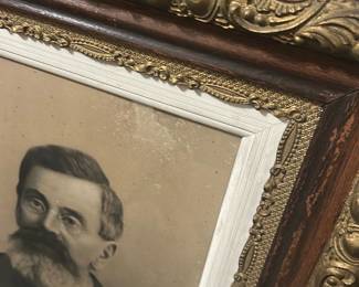 Ornate Oak Framed Portrait — Large framed portrait of a bearded gentleman in an ornate oak and gilt frame; the heavy carved molding and applied gilt ornament give this piece strong Victorian-era character. The portrait appears to be a charcoal or lithograph-style print behind original glass, set in a painted rabbet and decorative gilt liner. Overall substantial size (see dimensions) makes it well suited for a foyer or den; ideal for collectors of period frames or decorative salvage. Frame and print show surface grime, light spotting on the image, and some wear to the gilt and wood consistent with age but no major structural damage.
