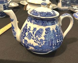 Wedgwood Blue & White Teapot — This classic Wedgwood teapot features the iconic blue and white transferware design typical of English porcelain craftsmanship. Made in England, it showcases detailed pastoral scenes with a traditional spout and handle, perfect for tea service. The teapot measures approximately 5.5 inches in height, 9 inches in width including the spout, and 5.5 inches in length from front to back, making it a practical yet decorative piece. It is in good condition with minor age-related wear consistent with use, and no visible chips or cracks. A fine example of Wedgwood's historic ceramic artistry, this teapot adds charm to any collection or table setting.