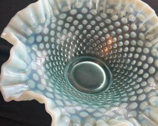 Fenton Aqua Opalescent Hobnail Bowl — This Fenton aqua opalescent hobnail bowl features the signature ruffled edge and raised hobnail pattern typical of classic Fenton art glass. Crafted from opalescent carnival glass, this bowl exhibits a beautiful light blue color that fades to milky white along the edges, adding visual depth and charm. Measuring approximately 4.5 inches tall with a 10-inch width and 10-inch length, it serves both as an elegant decorative piece and a functional bowl. The bowl is in excellent condition with no chips or cracks. A fine example of mid-20th century American glass artistry, this piece is a collectible treasure for Fenton glassware enthusiasts.