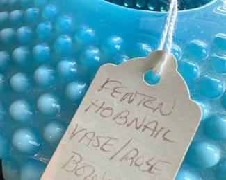 Fenton Blue Hobnail Vase/Rose Bowl — This charming Fenton blue hobnail vase and rose bowl combination exemplifies classic vintage glass artistry. Featuring a distinctive hobnail pattern in vibrant blue opalescent glass, it exhibits a rounded, flared form with a hollow center designed for holding roses or decorative floral arrangements. The piece measures approximately 3.5 inches high, 8 inches wide, and 8 inches deep, making it a delightful accent for any home decor. It is in good condition with minor surface wear consistent with age and use, with no visible cracks or chips. A beautiful collectible from the notable Fenton Glass Company, perfect for collectors and vintage decor enthusiasts.