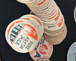 Vintage Pure Fresh Milk Bottle Caps — This collection features vintage milk bottle caps prominently marked with 'Pure Fresh Milk' in orange and blue. Made of cardboard, these circular caps showcase classic mid-century dairy branding and advertising. Each cap measures approximately 2.5 inches in diameter, perfect for collectors of dairy memorabilia or vintage advertising. The caps show some age-appropriate wear but remain intact and displayably collectible. A nostalgic set from the bonus up room, ideal for vintage & estate enthusiasts.