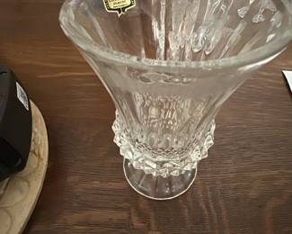 Zajecar Lead Crystal Vase — This elegant Zajecar crystal vase is crafted from 24% lead crystal and made in Yugoslavia. It features intricate cut-glass design elements, showcasing the clarity and brilliance typical of high-quality lead crystal. The vase measures approximately 9 inches in height and 7 inches in diameter, making it perfect for display or floral arrangements. It is in excellent condition with no visible chips or cracks, retaining its original brilliance. A classic example of European craftsmanship with timeless appeal.