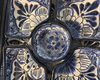 Blue Ceramic Chip & Dip Serving Set — This beautiful blue ceramic serving set features a chip and dip style arrangement with five pieces, each decorated with intricate floral and butterfly motifs in blue and cream colors. The set is crafted from glazed ceramic, making it both functional and decorative for entertaining guests. It measures approximately 12 inches wide and 2.5 inches tall, ideal for serving snacks and dips. The pieces are in excellent condition with no visible chips or cracks, showcasing their quality craftsmanship. A charming addition to any table setting or collection, this set is perfect for casual or formal occasions.