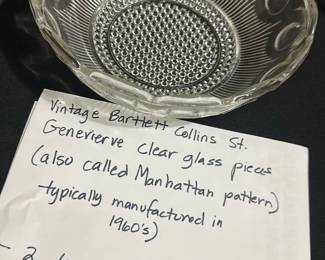 Bartlett Collins Clear Glass Bowl — This vintage Bartlett Collins clear glass bowl features the elegant Genevieve, also known as the Manhattan pattern, which was typically manufactured in the 1960s. The bowl has a classic round shape with intricate raised patterns that enhance its timeless appeal. Perfect as a large serving dish, this piece is an excellent example of mid-century glassware artistry. It is in good condition with no visible chips or cracks, retaining its clarity and detailed design. A collectible item for vintage glassware enthusiasts and mid-century collectors.