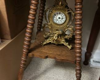Vintage Oak Accent Table with claw foot — This vintage oak accent table features intricately turned legs and a lower shelf The rich oak finish highlights the wood grain and adds warmth to any bedroom or living room. Measuring approximately 28 in height, 18 in width, and 12 in depth, this compact table offers decorative charm and practical surface space. It is in good condition with minor signs of wear consistent with age and use, and A lovely piece reflecting early 20th-century style and craftsmanship.