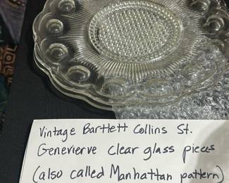 Bartlett Collins Clear Glass Plates — This set of vintage Bartlett Collins clear glass plates features the distinctive Genevieve or Manhattan pattern, popular in the 1960s. These large serving plates showcase intricate pressed glass details with a textured center and scalloped edges, embodying mid-century design elegance. Each plate measures approximately 11 inches in diameter, ideal for serving or display. They are in good vintage condition with minor surface wear consistent with age but no chips or cracks. Manufactured typically in the 1960s, these collectible glass pieces reflect classic American pressed glass craftsmanship.