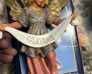 Fontanini Gloria Angel 7.5" — This Fontanini Gloria Angel from the 7.5" Heirloom Nativity Collection is a classic resin/finished-figure nativity angel. The piece is hand-painted in cream, pink and gold tones holding a banner reading "GLORIA" and shows the Fontanini and Roman, Inc. branding on the original box. Overall size is small and display-friendly for a mantel or nativity set; pictured with original box. In good used condition with light shelf wear to paint and minor scuffs consistent with normal use.