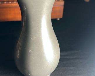 Royal Holland Pewter Vase by KMD — This elegant Royal Holland pewter vase by KMD Tiel displays an attractive curved form with a flared rim. Made in Holland, its smooth surface is classic and versatile for home decor. The vase measures approximately 7 inches in height and 4 inches in width, making it a perfect decorative accent. It is in good condition with minor surface scratches consistent with light use. This vintage piece reflects mid-century European craftsmanship.