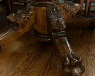 Carved Oak Round Dining Table 4’ — This exquisite round dining table features beautifully carved oak construction with claw foot pedestal legs, showcasing fine craftsmanship and vintage charm. The rich wood grain and detailed carvings on the base add a striking elegance suitable for any living room or dining area. Measuring approximately 48 inches in diameter and 30 inches in height, the table provides a stable and spacious surface for meals or gatherings. The piece is in good condition with normal wear and minor surface imperfections consistent with age. This vintage-style oak dining table combines function and ornate design for a timeless look.