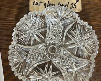 Cut Glass Decorative Bowl — This cut glass bowl features an intricate starburst and diamond pattern design with scalloped edges, perfect for adding a touch of elegance to your kitchen or dining area. The clear glass construction showcases excellent craftsmanship and classic decorative appeal. Measuring approximately 6.5 inches in diameter, it is suitable for serving or display purposes. The bowl is in good condition with no visible chips or cracks. Its timeless style complements both vintage and modern home decor.