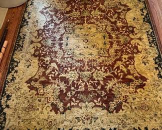 Traditional 3x5 Area Rug Red & Gold — This traditional area rug features a rich red center medallion with intricate gold and green floral patterns, framed by a dark border. The rug showcases a classic ornamental design perfect for entryways or living rooms, adding warmth and elegance to any space. Measuring approximately 58 inches wide by 89 inches long, it offers a substantial presence on hardwood floors. Condition is good with some wear visible on the fringe, consistent with regular use. A timeless decorative accent that complements both classic and transitional decor.