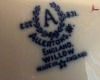 Allertons Blue Willow Creamer Pitcher — This charming Allertons creamer pitcher features the iconic blue willow pattern, a classic English design. Crafted from fine china, it showcases detailed scenic motifs in cobalt blue against a white background, embodying traditional craftsmanship from England. The creamer measures approximately 3.5 inches in height and 5 inches in width, perfect for serving cream or milk at the table. It is in good condition with no visible chips or cracks, maintaining its vintage appeal. Marked with the Allertons hallmark and 'Made in England,' this piece is a delightful collectible for lovers of classic English china.