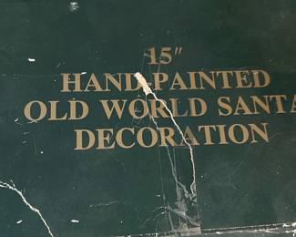 Holiday Expressions 15" Santa — This Holiday Expressions 15" hand-painted Old World Santa decoration is a festive collectible holiday figure. It appears to be a resin or polystone Santa with detailed paint, carrying gifts and a small reindeer at his feet, packaged in the original printed box. Box shows heavy wear and tape repairs; figure condition inside unknown but likely good if stored carefully — pictured box is worn. Great for seasonal mantle or tabletop display and ideal for estate-sale buyers seeking classic Old World holiday decor.