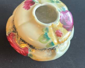 Vintage Floral Porcelain Hair receiver — This vintage floral porcelain anti hair receiver is a charming decorative piece often used in master bedrooms. It features a cream-colored base with hand-painted red, pink, yellow, and green floral designs accented by textured gold trim. The piece measures approximately 3.5 inches in height, 5 inches in width, and 5 inches in length, making it a compact yet elegant addition to any vanity or dresser. It is in good condition with minor crazing and surface wear consistent with age. The receiver bears a red maker's mark on its underside indicative of traditional porcelain craftsmanship.