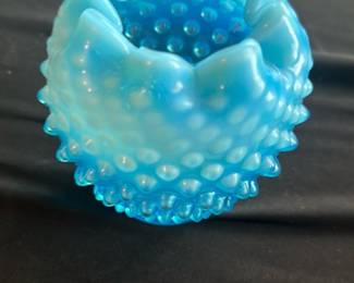 Blue Hobnail Glass Vase — This charming blue hobnail glass vase features a distinctive ruffled top edge and textured hobnail pattern throughout the body. The vase has a gradient of blue hues from a lighter shade at the top to a deeper blue at the base. Measuring approximately 4.5 inches tall and 4 inches wide, it is a lovely accent piece for any room and ideal for small floral arrangements. The vase is in good condition with minor surface wear consistent with age but no chips or cracks. Its vintage design makes it a collectible addition to glassware displays or home decor collections.