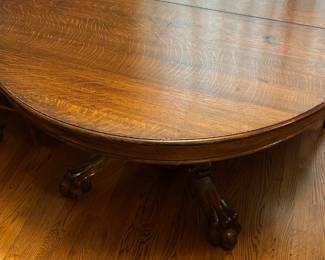 Carved Oak Round Dining Table 4’ — This exquisite round dining table features beautifully carved oak construction with claw foot pedestal legs, showcasing fine craftsmanship and vintage charm. The rich wood grain and detailed carvings on the base add a striking elegance suitable for any living room or dining area. Measuring approximately 48 inches in diameter and 30 inches in height, the table provides a stable and spacious surface for meals or gatherings. The piece is in good condition with normal wear and minor surface imperfections consistent with age. This vintage-style oak dining table combines function and ornate design for a timeless look.