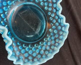 Fenton Blue Hobnail Opalescent — This Fenton blue hobnail opalescent bowl is a stunning vintage collectible piece. Featuring a ruffled edge and distinctive hobnail pattern, it measures 1⅝ inches tall with a side turned up design. The bowl is crafted from opalescent glass showcasing vibrant shades of blue with excellent craftsmanship. It is in good condition with minor signs of use but no chips or cracks visible. A classic example of Fenton's renowned glass artistry, perfect for decorative display or collection.
