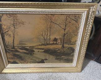 Framed Landscape Oil Painting — Large framed landscape oil painting depicting a riverside cottage scene with trees and muted autumn tones. The work is set in an ornate gold gilt wooden frame with decorative inner moulding; canvas appears to be oil on canvas or board. Overall piece is a substantial wall accent suitable for living room or entry; measurements provided below are approximate. Condition shows age-consistent surface craquelure and light wear to the gilt frame corners and finish but no visible tears to the canvas. No visible signature or maker's mark on the front; sold as decorative estate artwork.