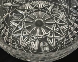 Crystal Bowl with Feet — This crystal bowl with feet is a beautifully crafted decorative piece featuring intricate cut glass patterns. The bowl is clear crystal with detailed floral and geometric cuts, creating a sparkling effect. It is designed with three sturdy crystal feet for stability and elegance. Measuring approximately 7 inches in diameter and 3.5 inches in height, it is perfect for display or serving. The item is in excellent condition with no chips or cracks visible.