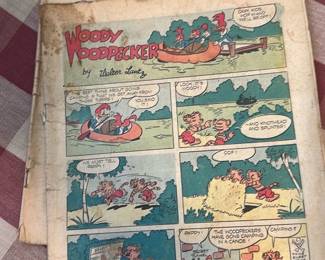 Uncle Scrooge / Woody Woodpecker Comics — Two vintage full-page comic sections featuring Uncle Scrooge and Woody Woodpecker by Walter Lantz. Both issues are loose comic pages/sections with age toning, foxing, edge wear, and light soiling but readable panels and intact imagery. Approximate paper folio size makes them suitable for collectors, restoration, or framing; sold as-is from the Office Up Room. Condition shows typical mid-century paper deterioration including creases, small tears at edges, and discoloration; not restored.