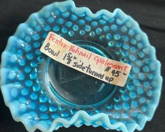 Fenton Blue Hobnail Opalescent — This Fenton blue hobnail opalescent bowl is a stunning vintage collectible piece. Featuring a ruffled edge and distinctive hobnail pattern, it measures 1⅝ inches tall with a side turned up design. The bowl is crafted from opalescent glass showcasing vibrant shades of blue with excellent craftsmanship. It is in good condition with minor signs of use but no chips or cracks visible. A classic example of Fenton's renowned glass artistry, perfect for decorative display or collection.