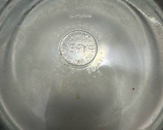 Vintage Pyrex Glass Frying Pan — This vintage Pyrex frying pan features a sturdy glass cooking surface combined with a metal rim and a clear acrylic handle. The pan's base is marked with the Pyrex logo and manufacturing details, confirming its authenticity and classic design. Measuring approximately 11 inches in diameter with a handle length of about 7 inches, this piece is ideal for collectors or vintage kitchen enthusiasts. It shows signs of use consistent with its age but remains structurally sound with no major chips or cracks. A distinctive vintage kitchen collectible that blends glass and metal materials for a unique cooking accessory.