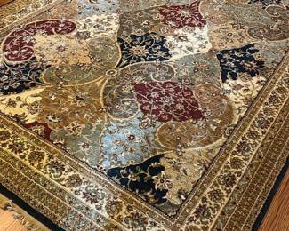 Shaw Rugs Multi-Color Area Rug  8 x11 — This Shaw Rugs multi-color area rug features a rich, intricate pattern in warm and cool tones including red, gold, blue, and black. Woven from 100% nylon pile, it offers durability and a soft texture underfoot, perfect for adding character to the dining room. Measuring precisely 2.3622 by 3.3782 meters (7'9"), it fits well in medium-sized spaces. The rug is in good condition with minimal wear and intact fringes. Made in the USA in 2002, this rug is a quality piece from a reputable manufacturer.