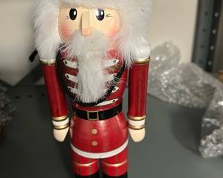 Red King Nutcracker Figure — This decorative red king nutcracker makes a festive statement with a painted gold crown and faux white fur beard. Crafted of painted wood with fabric/feather trim, it stands on a round base and features hand-painted facial details and uniform accents. Ideal for holiday mantel or entry display; estimated at about 18 inches tall and easy to set among seasonal decor. In good condition with light surface wear to paint consistent with display use.